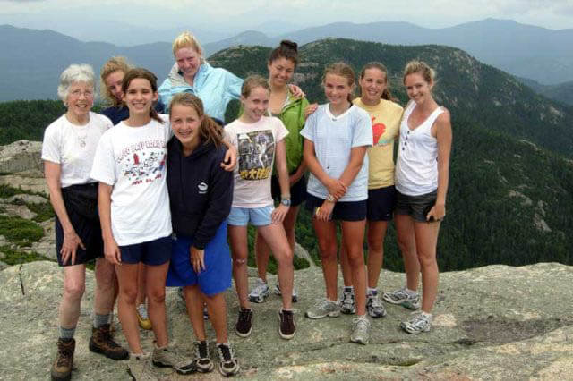 Alice Waterman on top of a mountain with campers